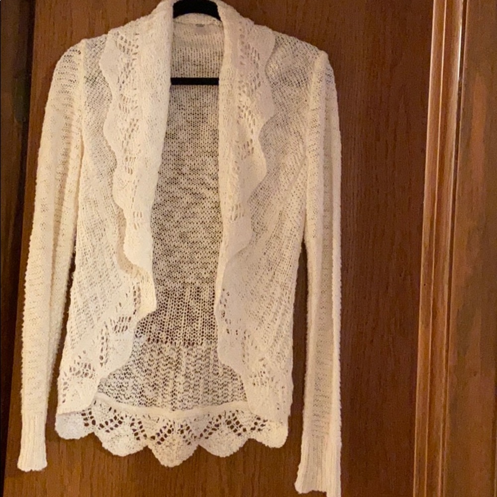 Cream in color sweater/cardigan like.